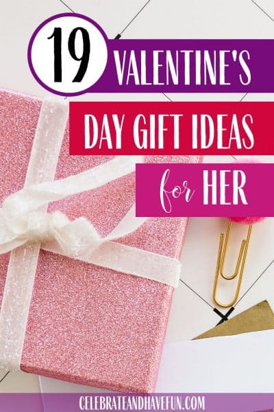 A pink gift wrapped present with a white bow for Valentine's Day
