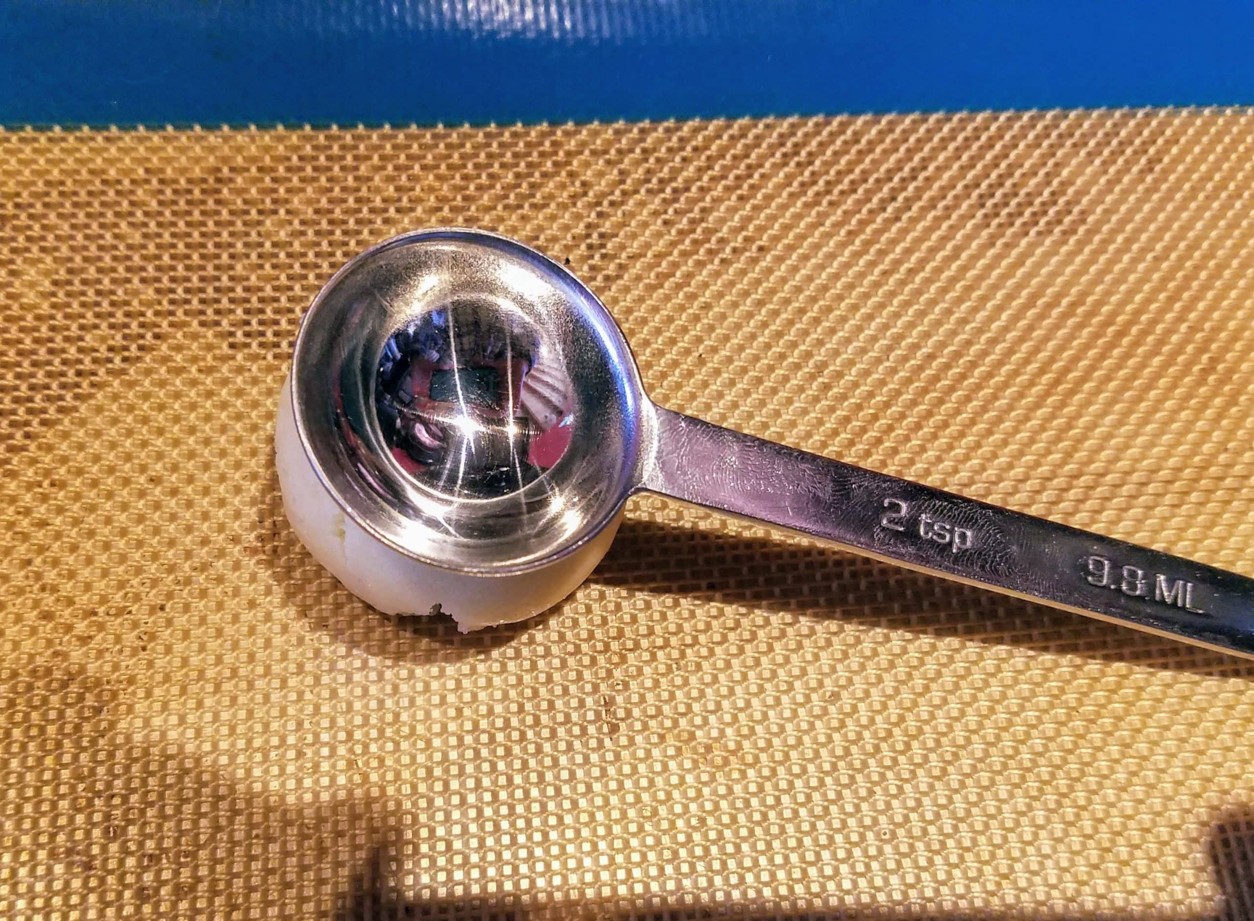 use a metal measuring spoon to make the well