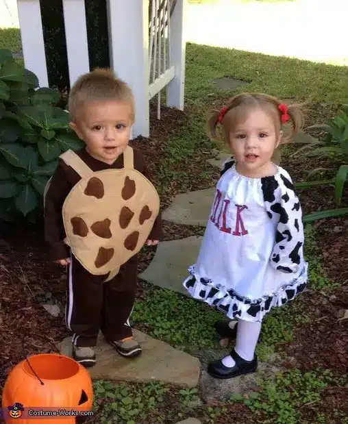 Twin Halloween costume with cookies and milk.