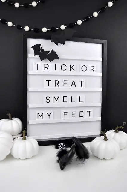 Letter board that says "trick or treat smell my feet"