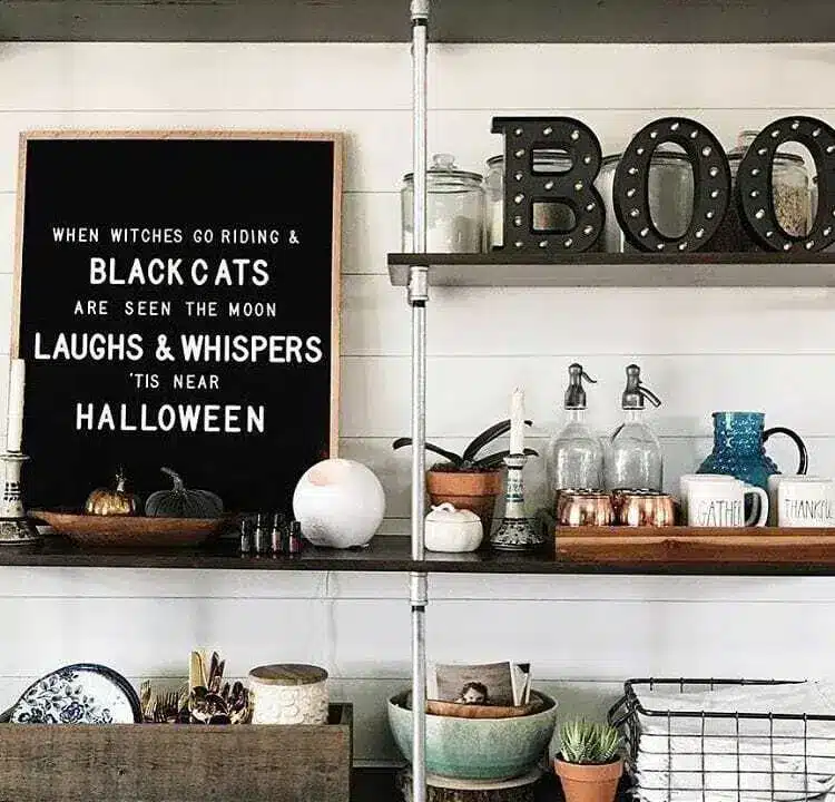 Letter board that says "when witches go riding & black cats are seen the moon laughs & whispers 'tis near halloween"
