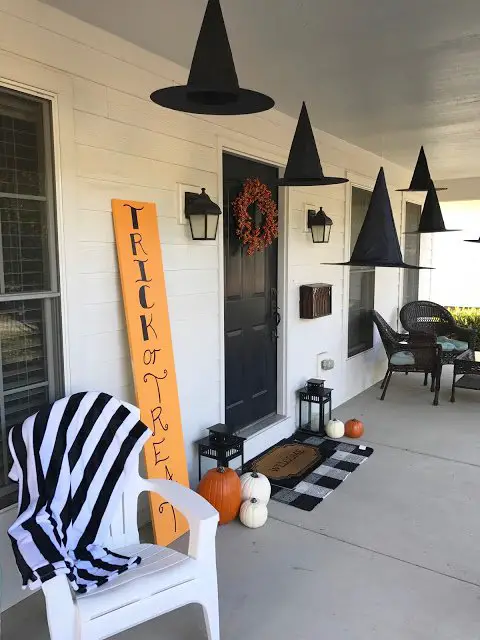 Decorate your porch for Halloween using witch hats and a trick or treat sign