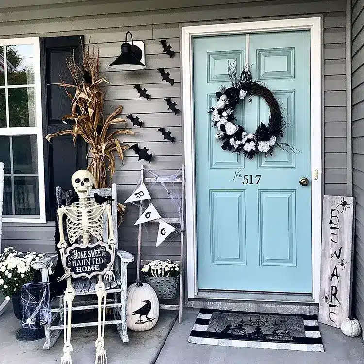 Halloween door area decorated with bats and a skeleton