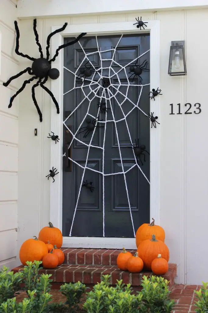 Decorate your porch with spiders and a spiderweb for Halloween