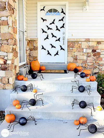 Halloween porch with bats, pumpkins, and spiders