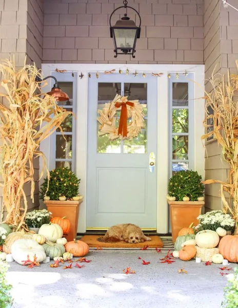 Decorate your fall porch with corn stalks, pumpkins, and a wreath