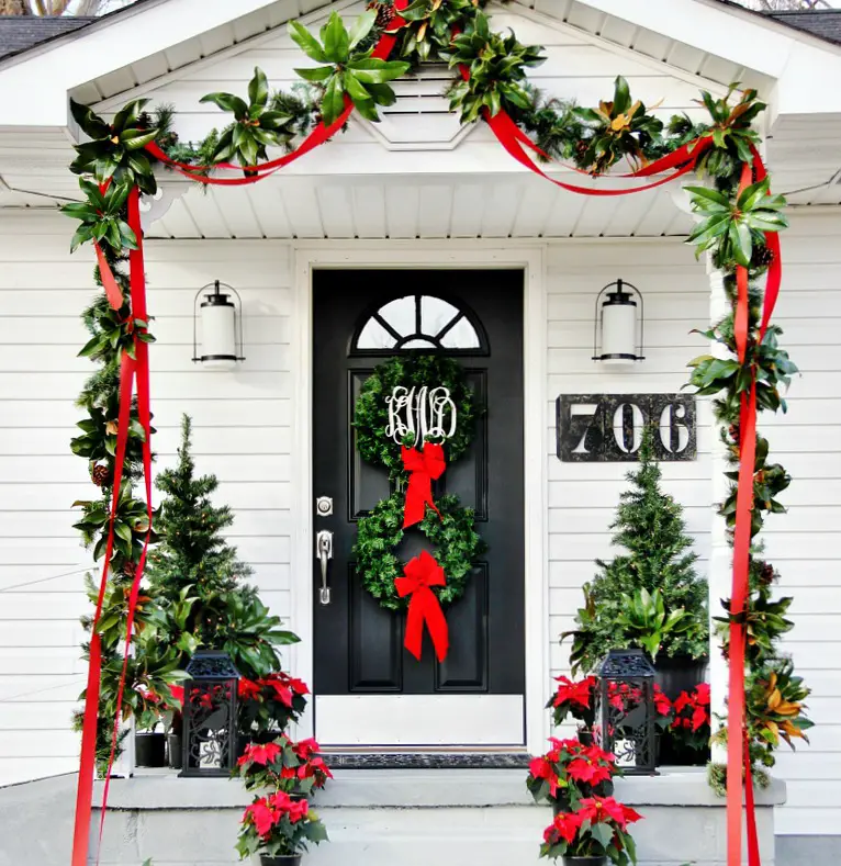Farmhouse Christmas decorations with wreaths, garlands, and poinsettias