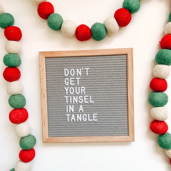 letter board that says "don't get your  tinsel in a tangle"
