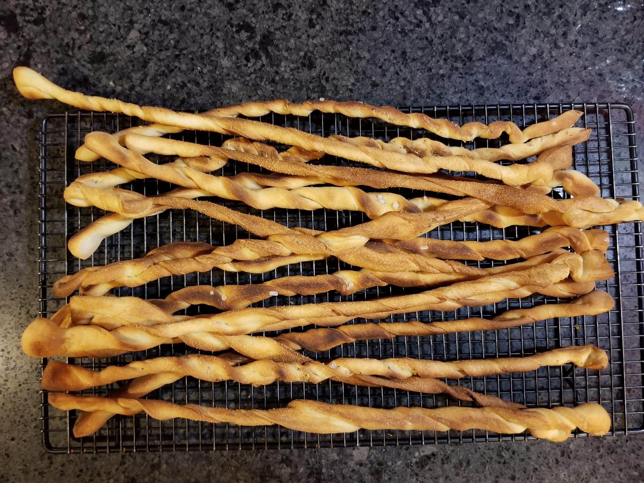 homemade breadsticks cooling on rack