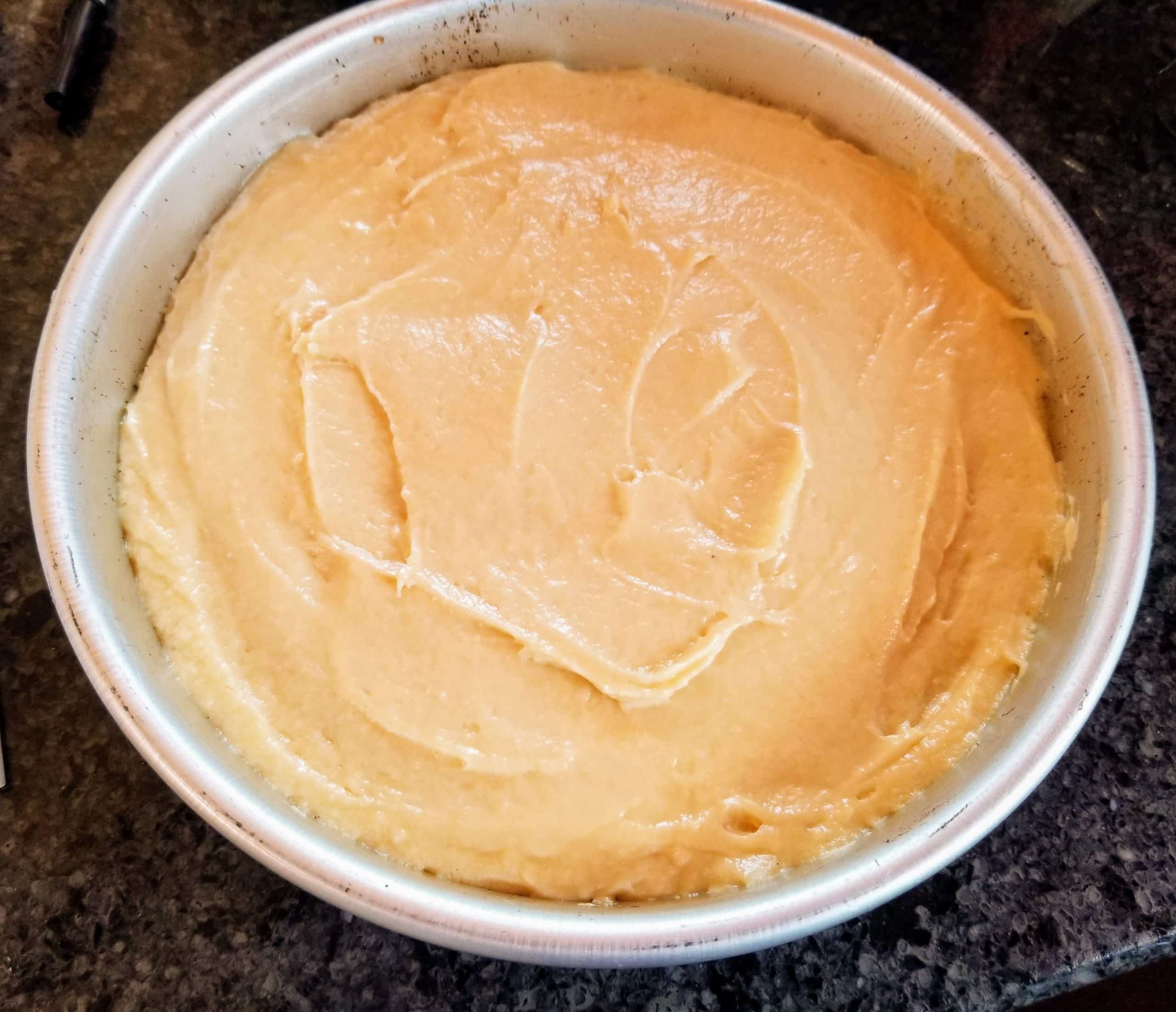 add batter on top of cherries and smooth with a spatula
