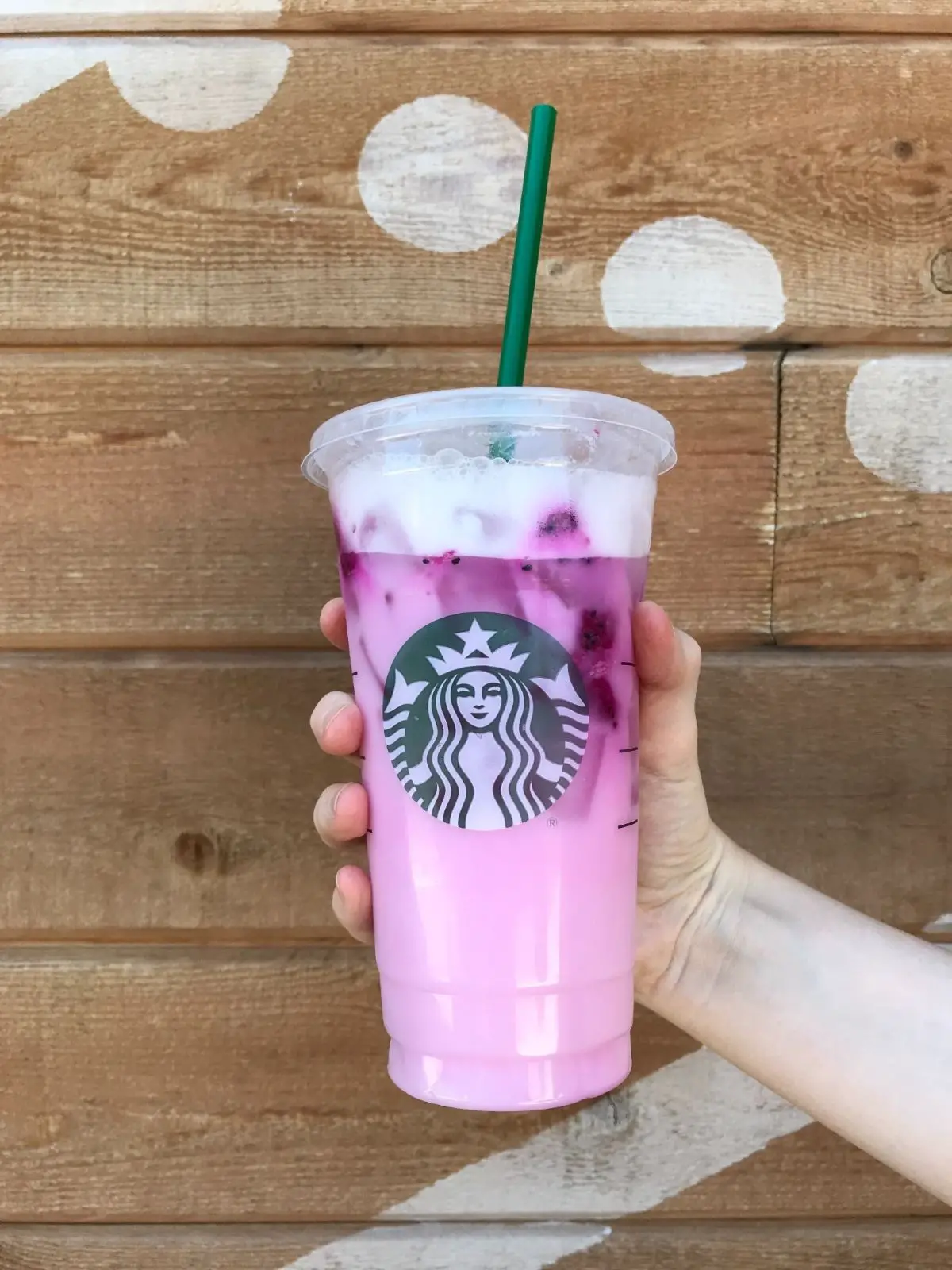 the dragon drink from starbucks with a wood wall background
