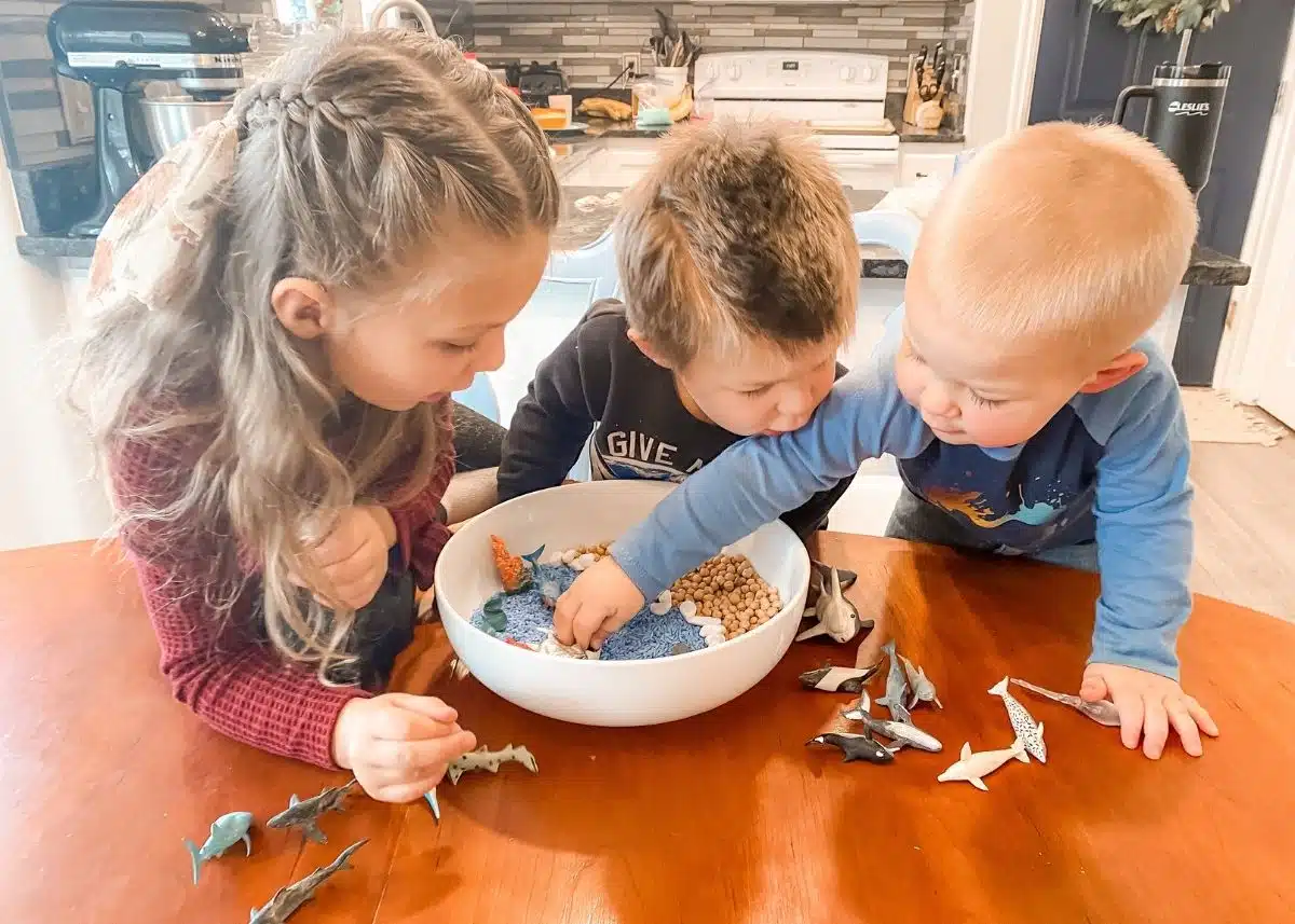 All three of my kids playing with the ocean sensory tray.