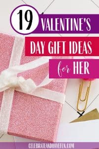 A pink gift wrapped present with a white bow for Valentine's Day