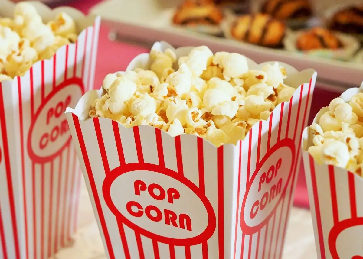 Three buckets of movie theater popcorn.