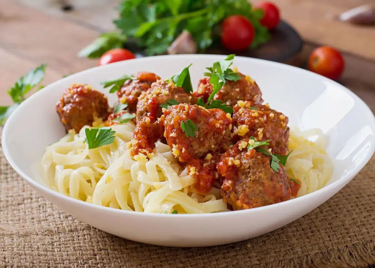 A closeup of a beautiful bowl of spaghetti and meatballs.