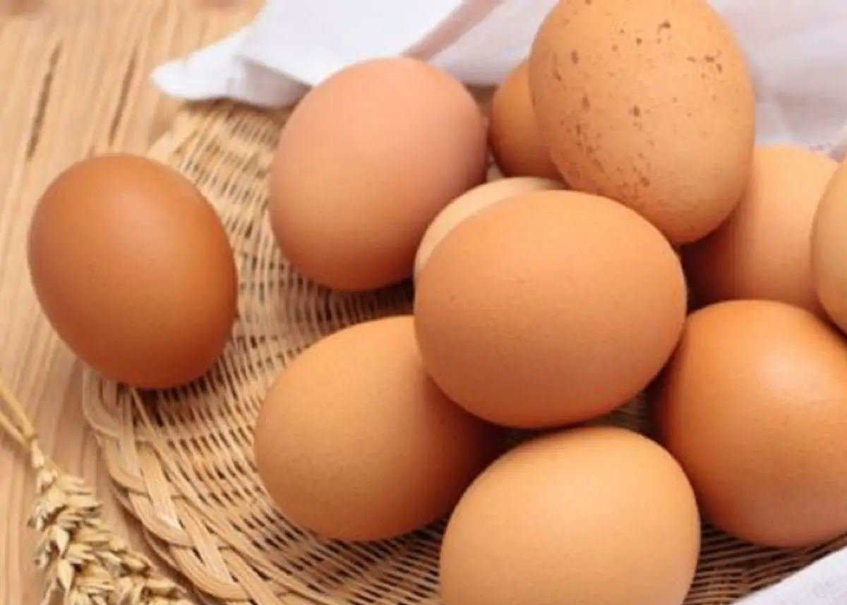 A close up of a dozen brown eggs.  