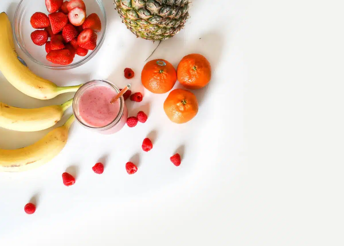 An overhead shot of a smoothie and smoothie ingredients.