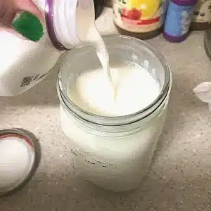 Half and half being poured into a mason jar