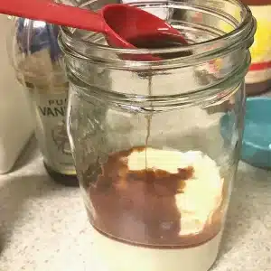 Vanilla being poured into a mason jar