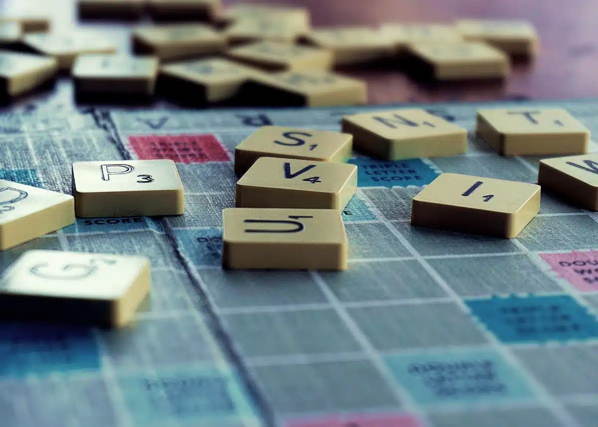 A closeup of Scrabble letters on a Scrabble board.