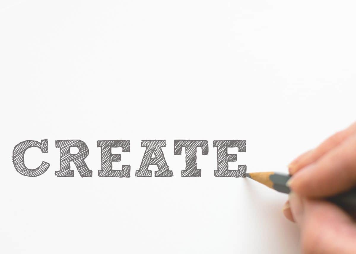 Someone is writing the word "CREATE".  They're writing it in block letters.  