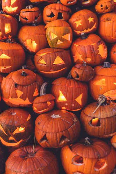 This is a photo of about 20-30 jack-o-lanterns in a huge pile.