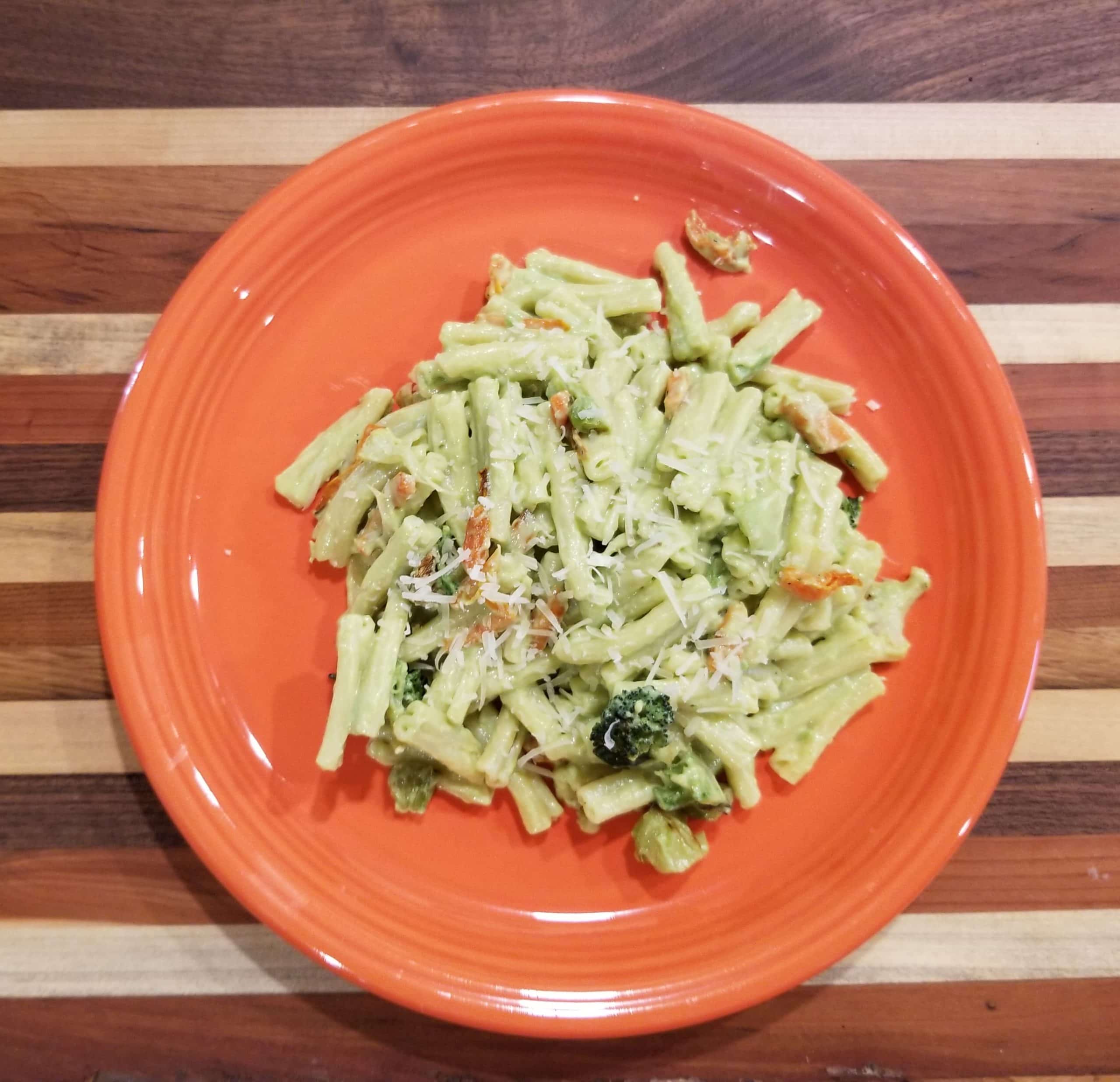 pasta with avocado sauce on orange plate